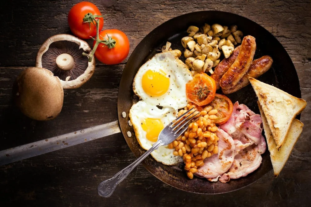 English breakfast with eggs, sausages, and toast