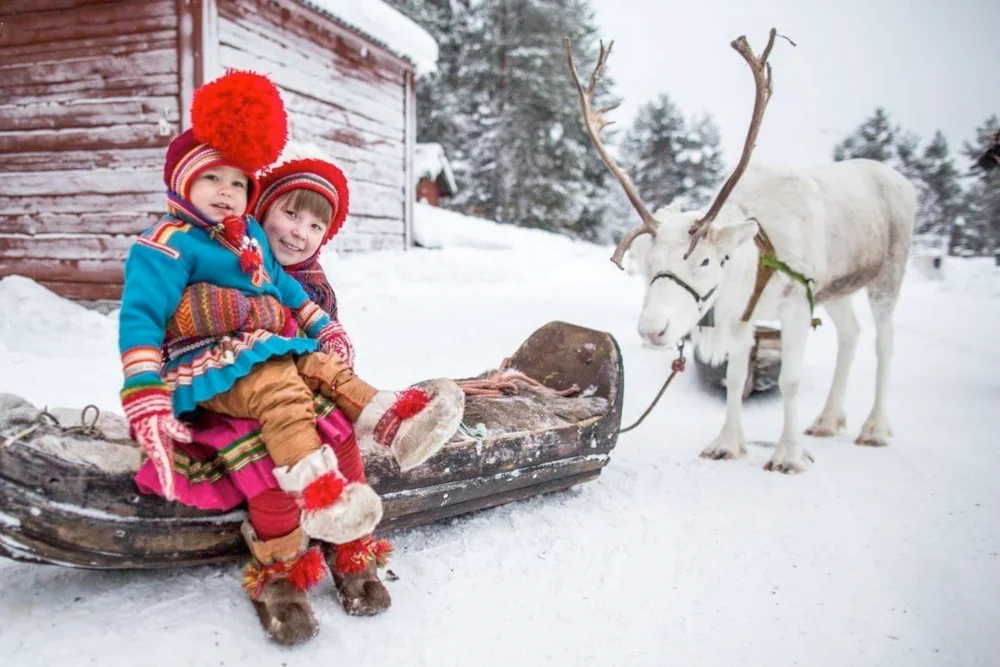 Sami children in Lapland with reindeer sled.